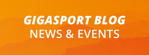 Fond orange avec silhouettes de montagnes. Le texte blanc indique "GIGASPORT BLOG ACTUALITÉS & ÉVÉNEMENTS".