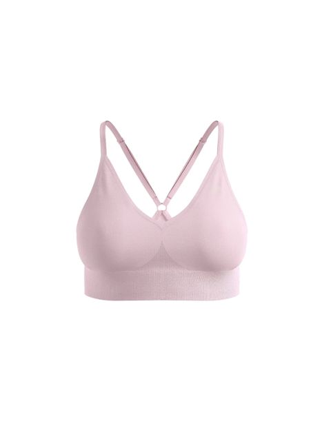 Bralette rose pâle sans couture avec bretelles croisées réglables sur fond blanc.