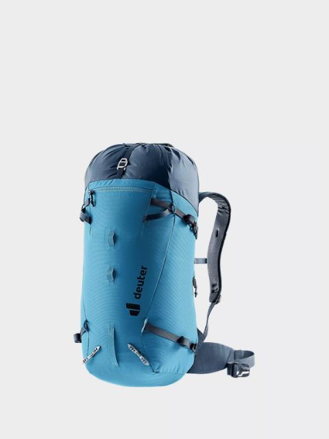 Sur un fond gris clair, on voit un sac à dos Ortovox vert avec des poches latérales en filet et des fixations pour piolet. En haut à gauche, on peut lire en lettres blanches grasses « Sacs à dos Alpin ».