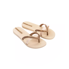 Une paire de tongs beiges avec des brides marron et rose clair sur un fond blanc circulaire.