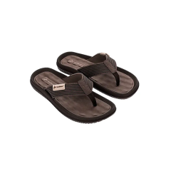 Une paire de sandales tongs marron et noir avec des brides texturées sur un fond blanc circulaire.